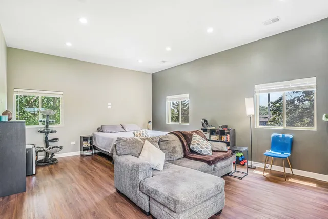 a living room with furniture and a wooden floor