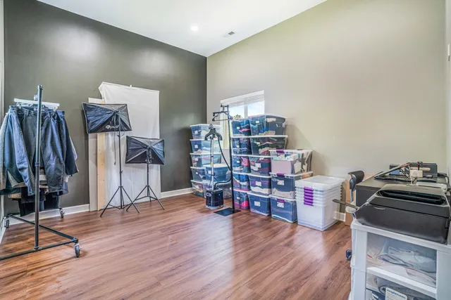 a living room with lots of furniture and a wooden floor
