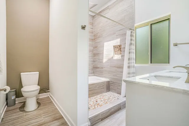 a bathroom with a sink toilet and shower