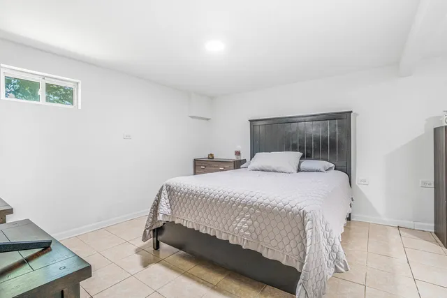 a bedroom with a bed and window