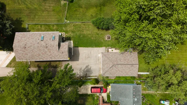 an aerial view of a house with a yard