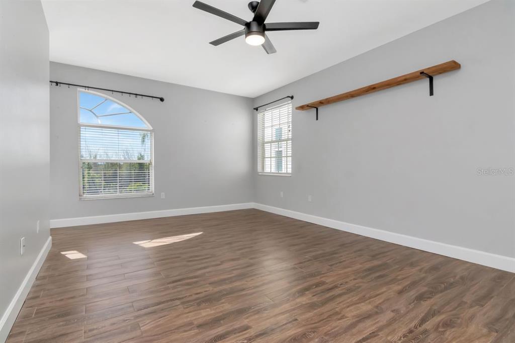 5313 Boardwalk Street Holiday, FL 34690 - Photo 35 of 69 a view of an empty room with wooden floor and a window