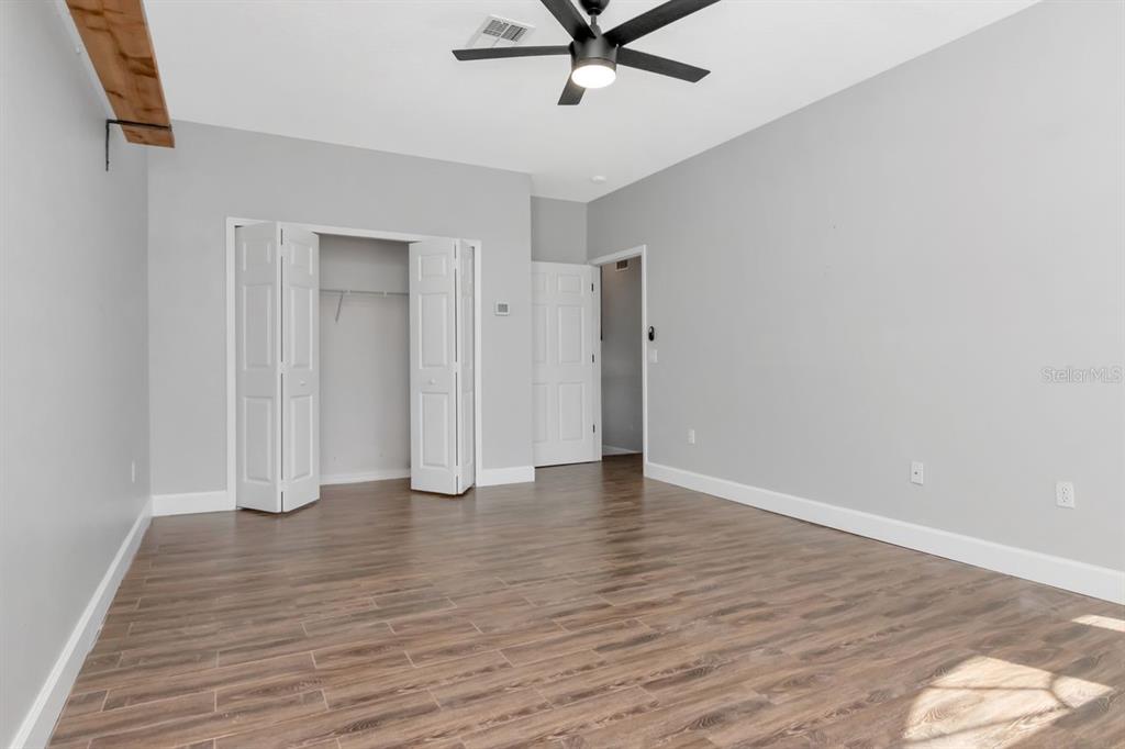 5313 Boardwalk Street Holiday, FL 34690 - Photo 37 of 69 an empty room with wooden floor and windows