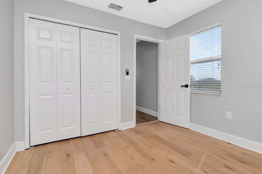 5313 Boardwalk Street Holiday, FL 34690 - Photo 53 of 69 a view of an empty room with wooden floor