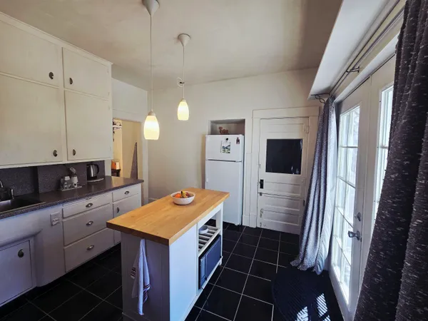 a kitchen that has a fridge and a stove in it