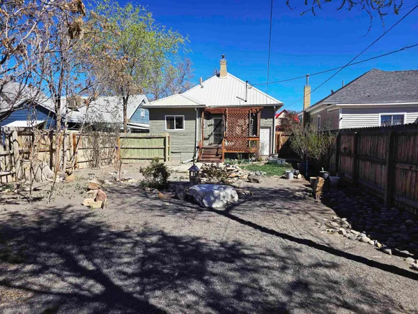 a view of a house with backyard and sitting area