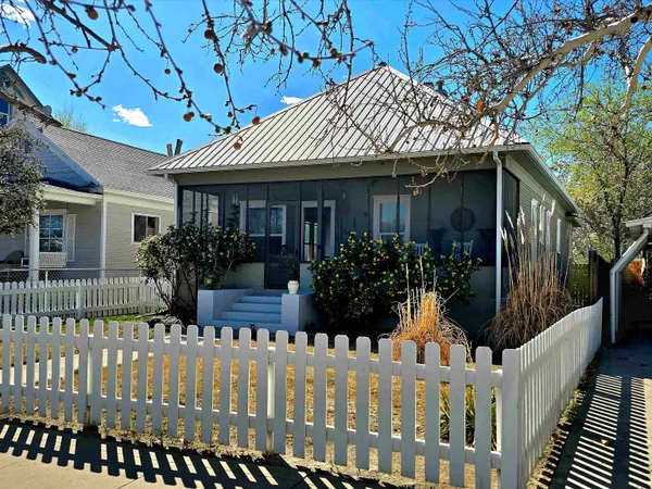 a front view of house with wooden fence