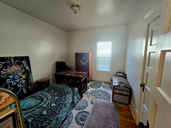 a bedroom with furniture and a window