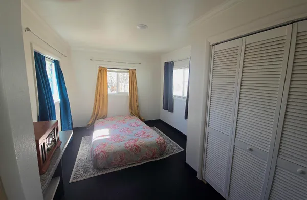 a bedroom with a bed and a mirror