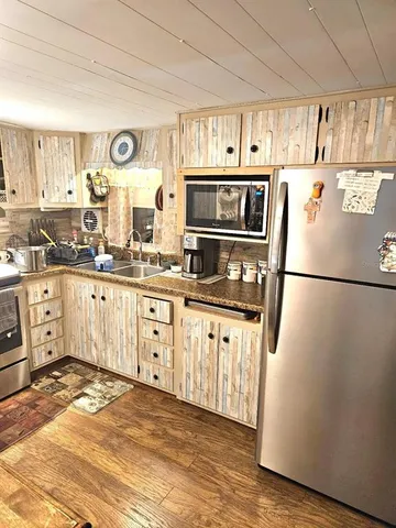 a kitchen with stainless steel appliances a stove a sink and a microwave