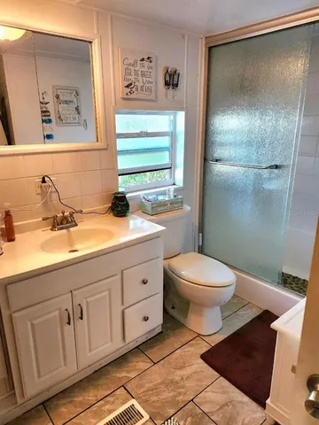 a bathroom with a shower and a toilet