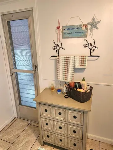 a view of a bedroom with furniture and window