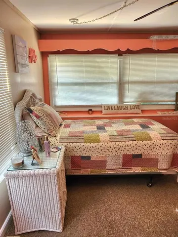 a bed room with a bed and window