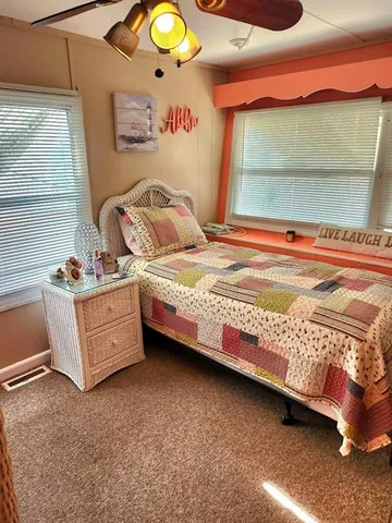a bedroom with a bed and a mirror