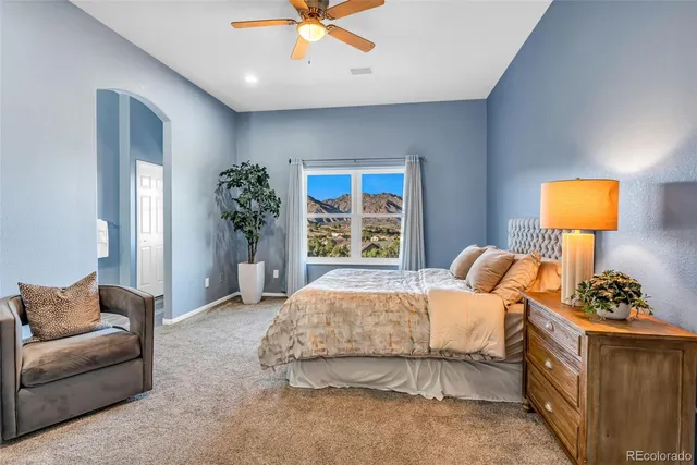 a bedroom with a bed lamps and table