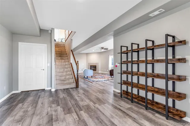 a view of a livingroom with furniture and staircase