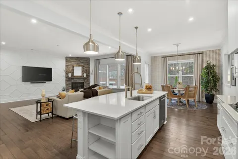 a large white kitchen with a table and chairs