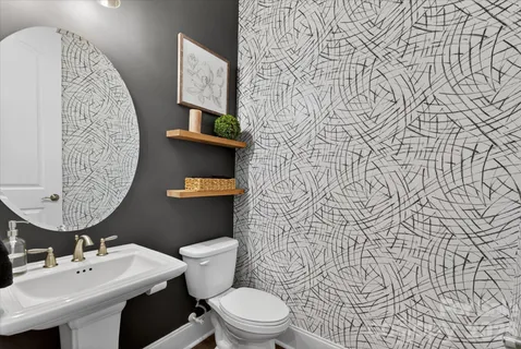 a bathroom with a toilet sink and shower curtain