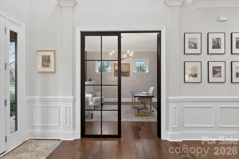 a view of empty room with wooden floor and windows