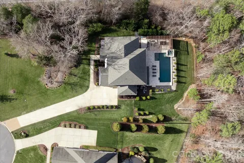 an aerial view of a house with garden space ocean and mountain view in back