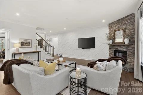 a living room with furniture a fireplace and a flat screen tv