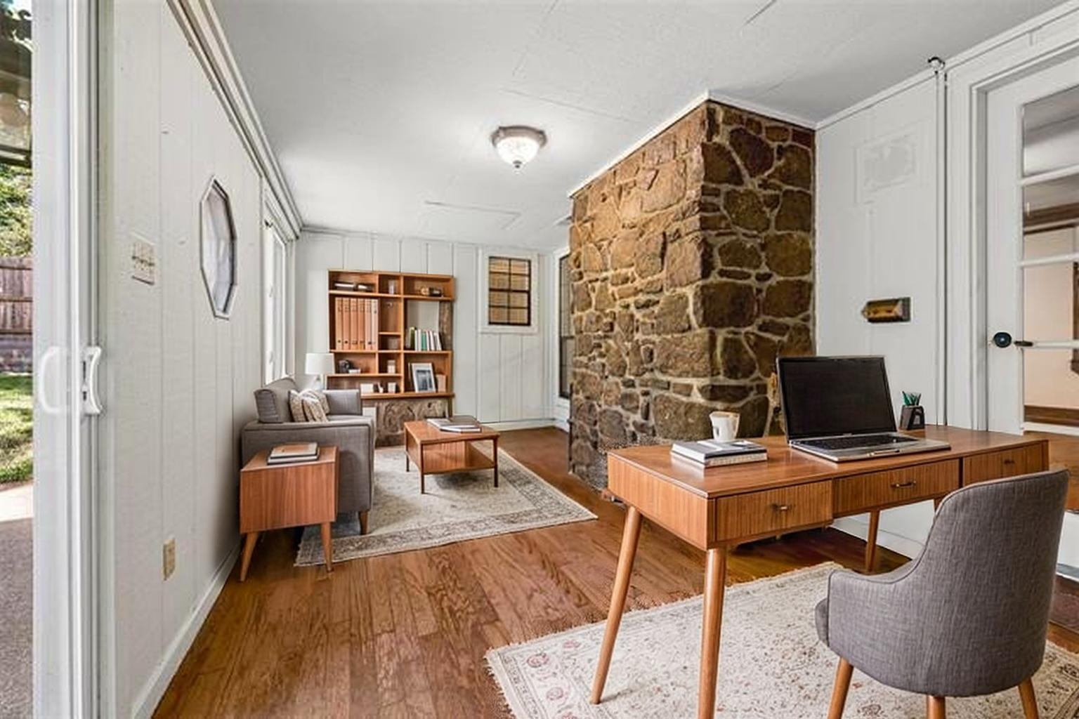 8970 Farmoor Road Germantown, TN 38139 - Photo 22 of 40 Stone accent wall, wood-finish flooring, white paneled walls, built-in shelving, glass-paned door