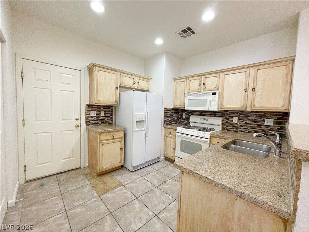 691 Principle Point Avenue Henderson, NV 89012 - Photo 9 of 30 A well-appointed kitchen features ample cabinetry and durable granite countertops, perfect for daily meal preparation.