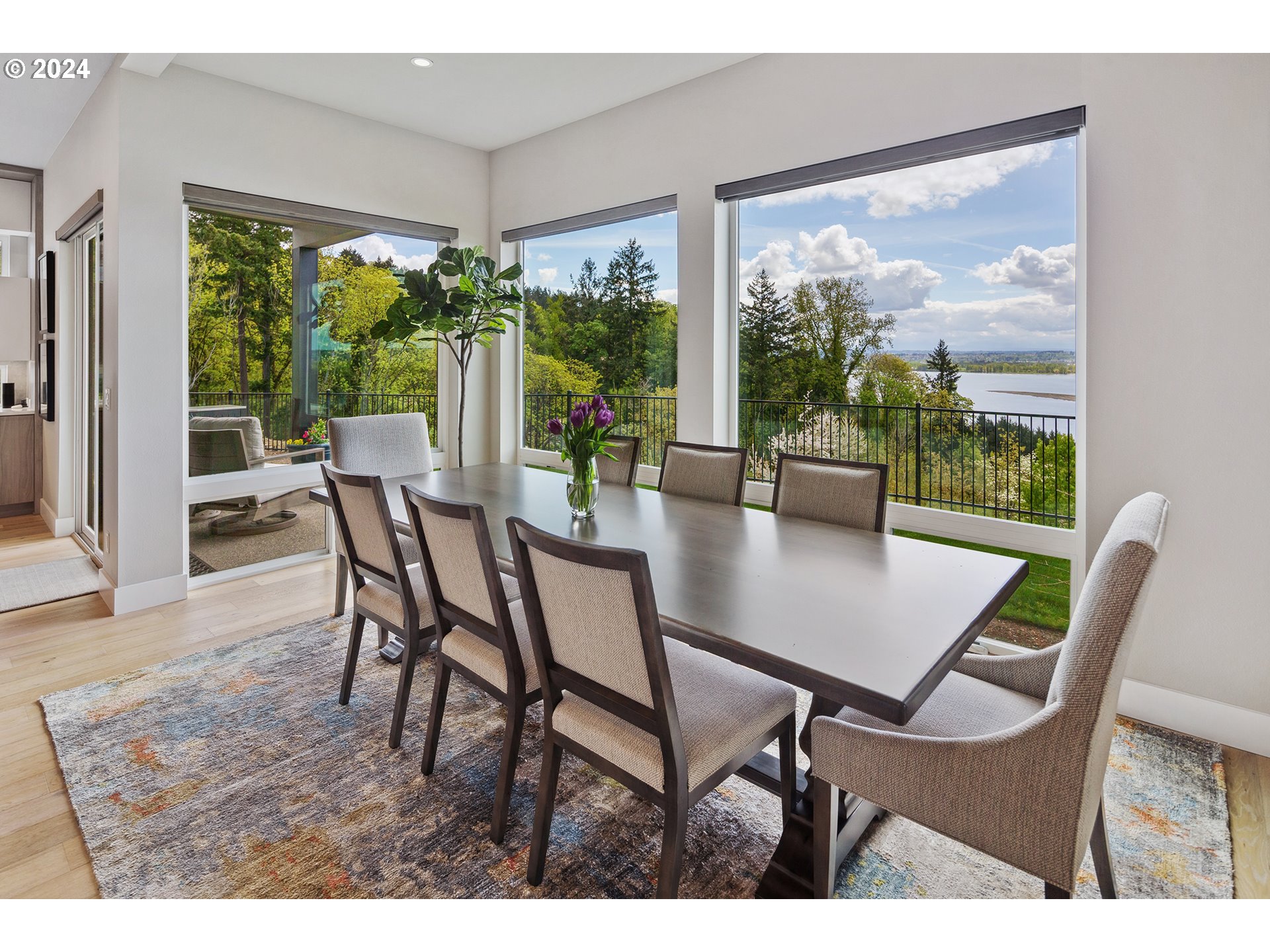 19915 Southeast Ascension Loop Camas, WA 98607 - Photo 14 of 42 a view of a dining room with furniture large windows and wooden floor