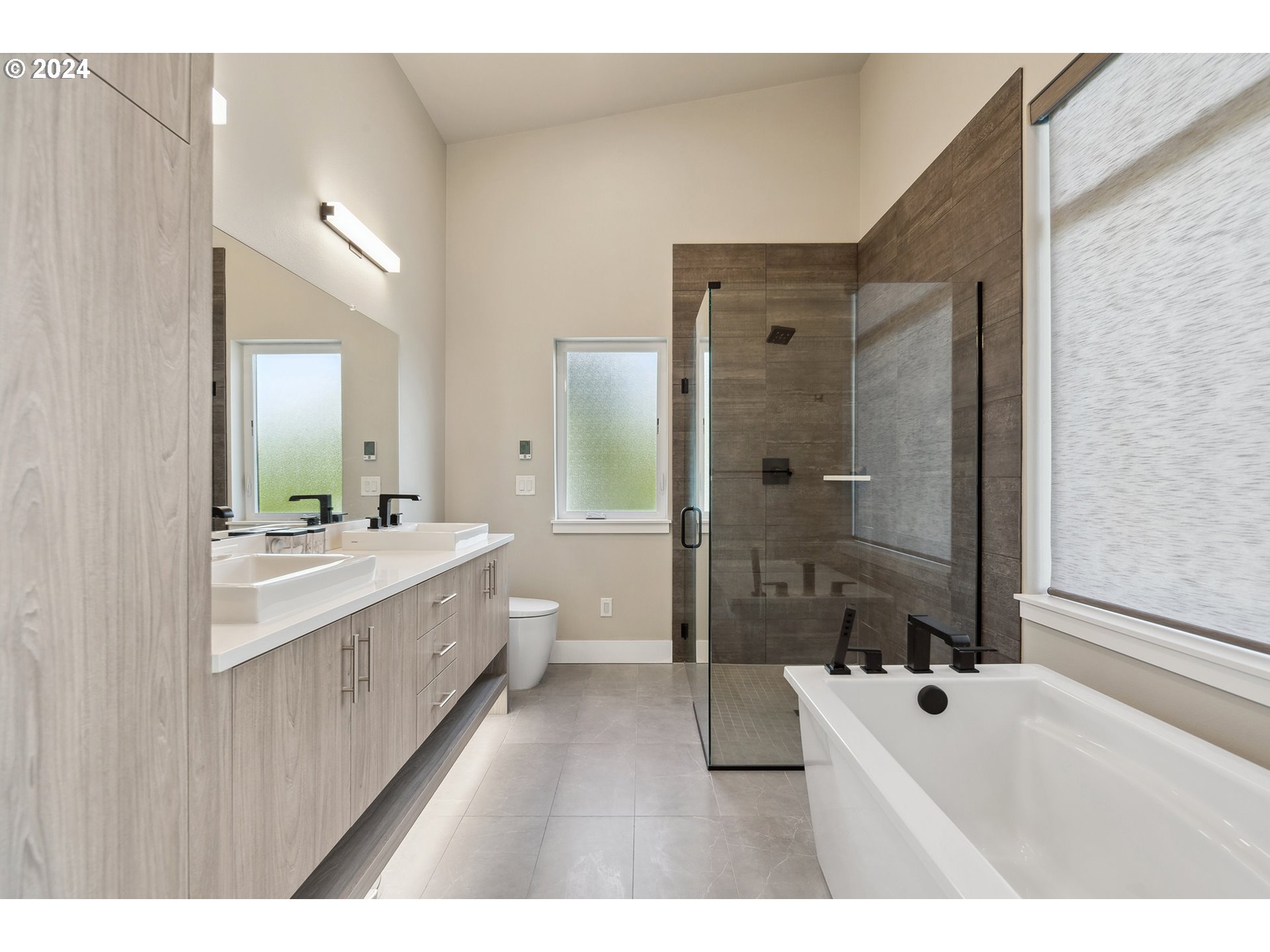 19915 Southeast Ascension Loop Camas, WA 98607 - Photo 29 of 42 a bathroom with a double vanity sink a toilet a mirror and shower