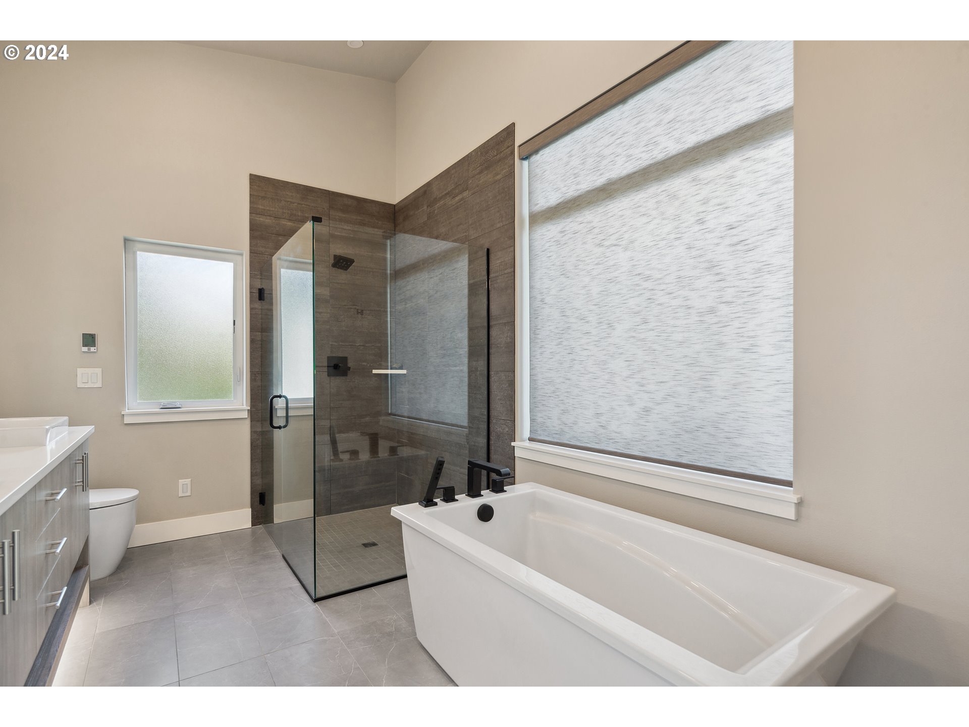 19915 Southeast Ascension Loop Camas, WA 98607 - Photo 30 of 42 a bathroom with a bathtub a toilet and a shower