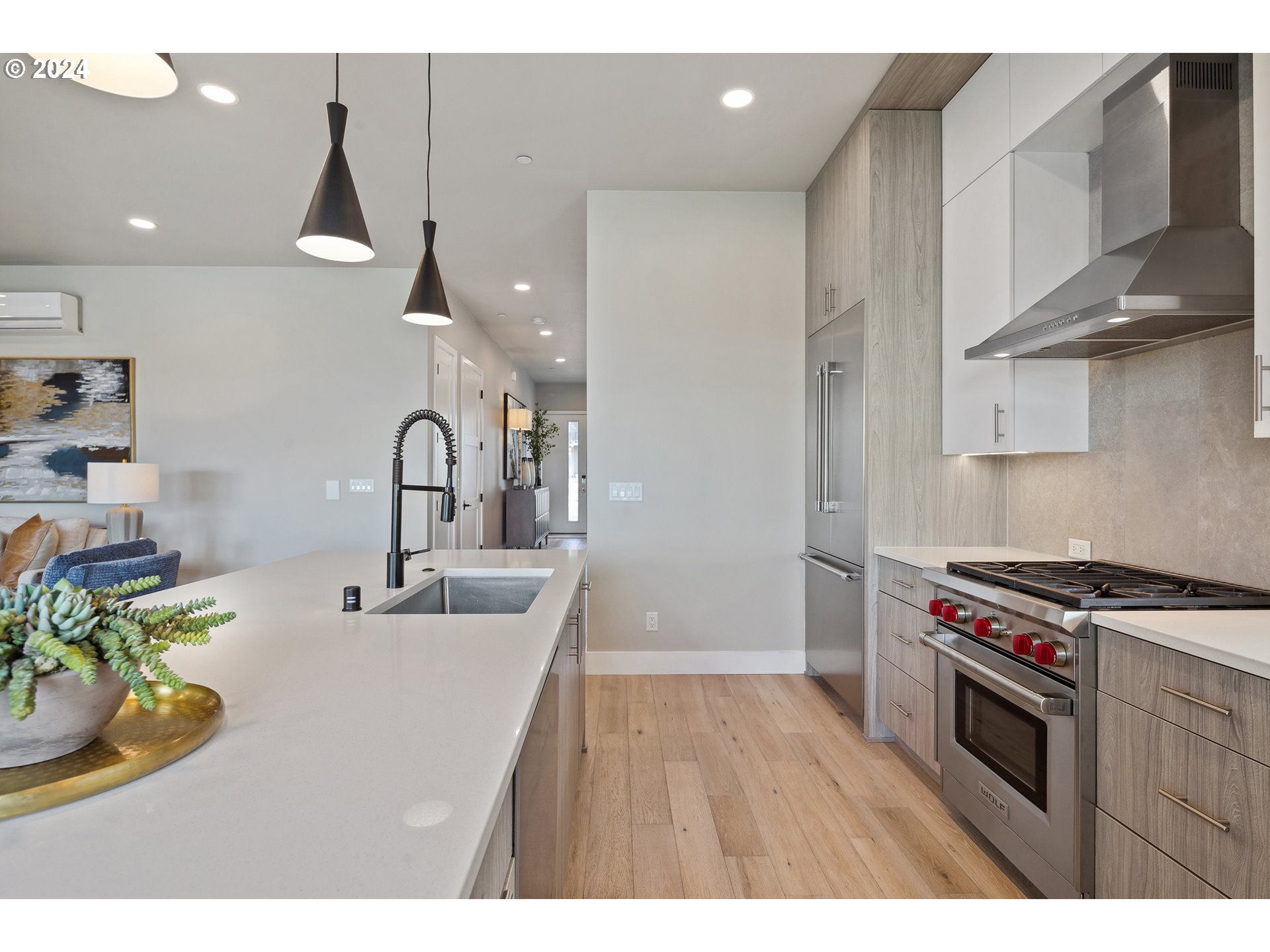 19915 Southeast Ascension Loop Camas, WA 98607 - Photo 6 of 42 a kitchen with stainless steel appliances granite countertop a sink a stove and a wooden floors