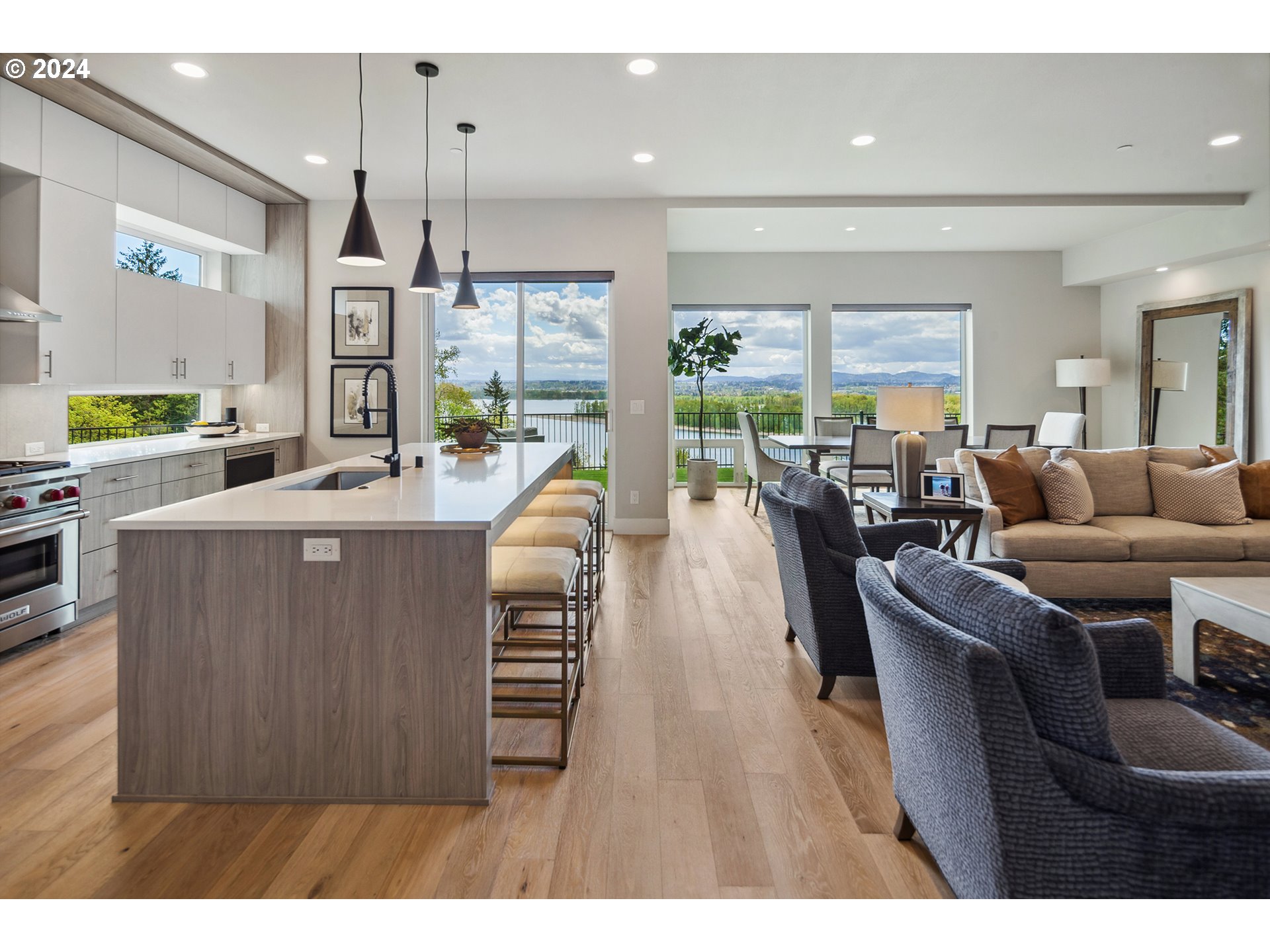19915 Southeast Ascension Loop Camas, WA 98607 - Photo 9 of 42 a living room with furniture a large window and a chandelier
