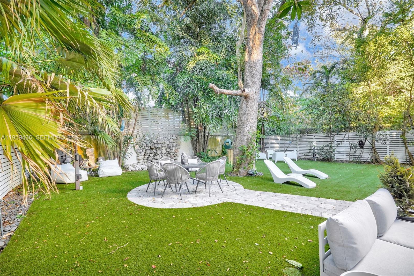 3675 Loquat Avenue Miami, FL 33133 - Photo 16 of 65 a view of a table and chairs in the patio