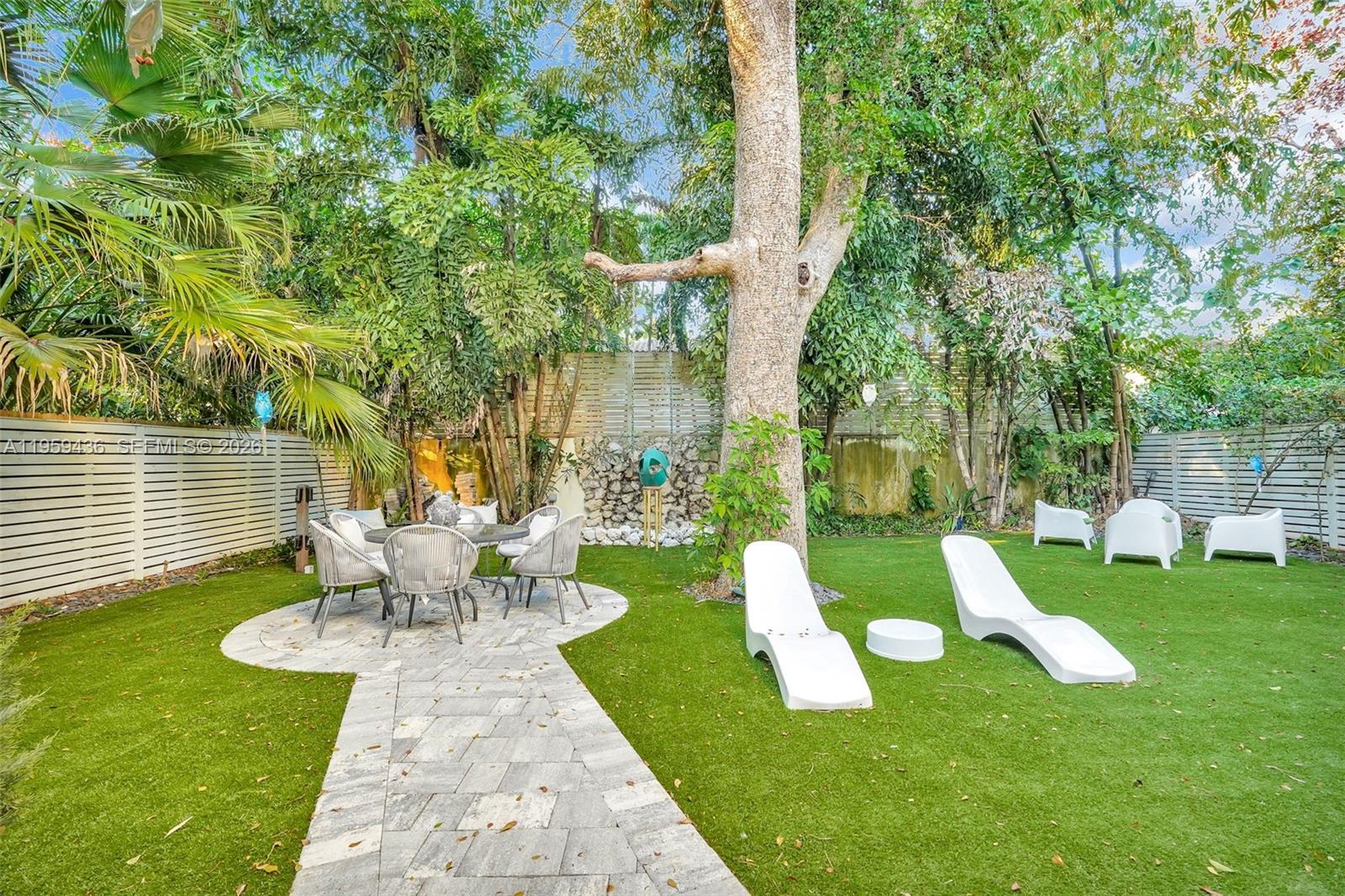 3675 Loquat Avenue Miami, FL 33133 - Photo 17 of 65 a view of a chair and table in backyard of the house