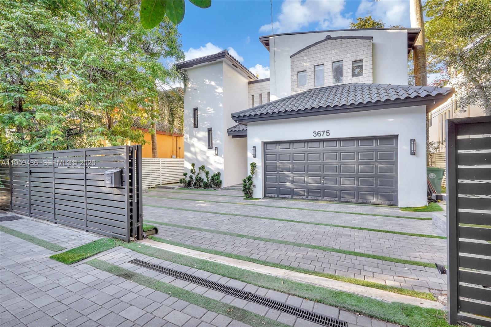 3675 Loquat Avenue Miami, FL 33133 - Photo 2 of 65 a front view of a house with a small garden