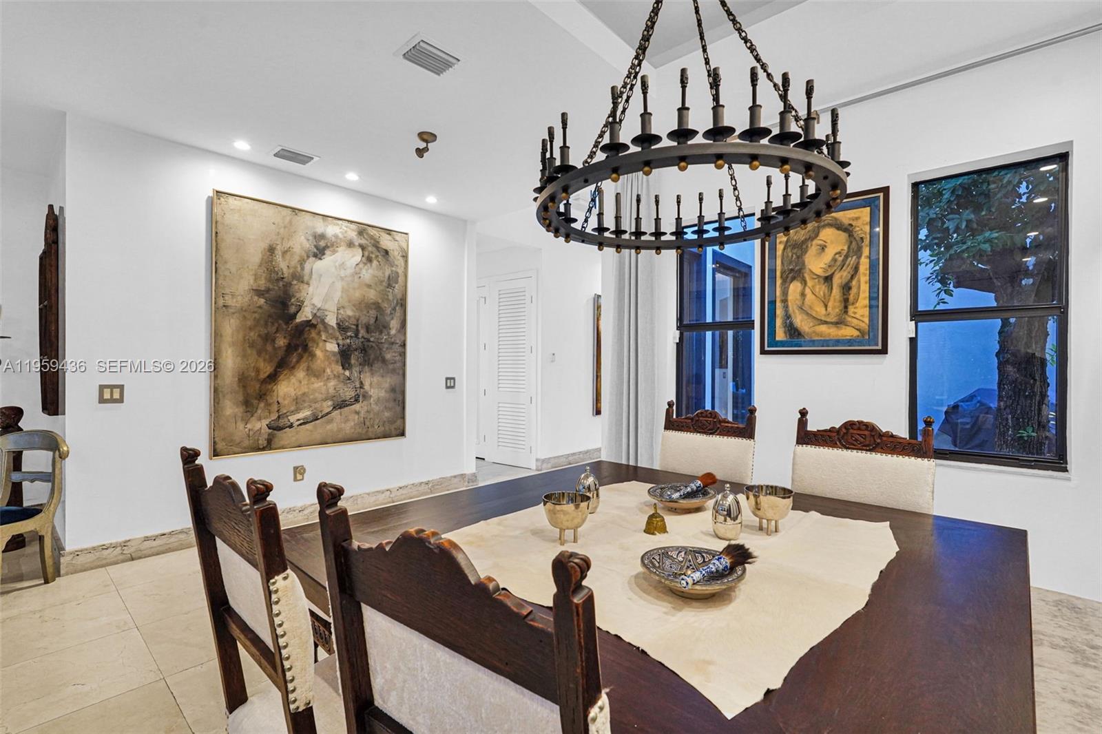3675 Loquat Avenue Miami, FL 33133 - Photo 32 of 65 a view of a dining room with furniture and chandelier