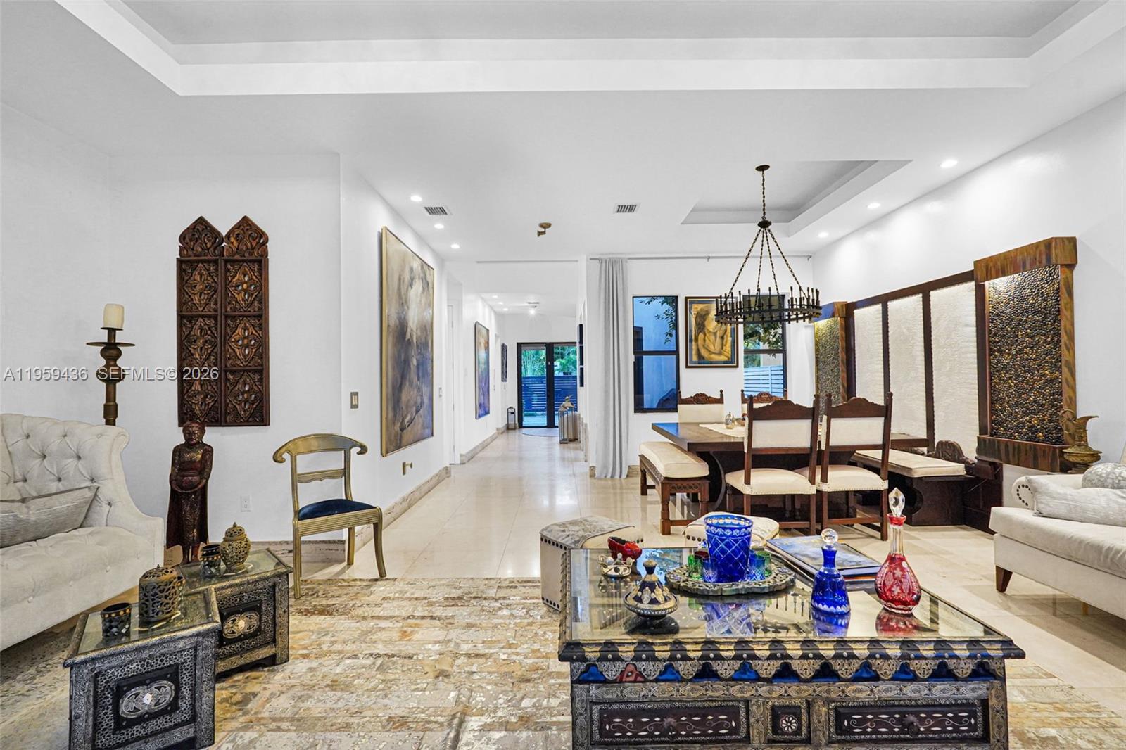 3675 Loquat Avenue Miami, FL 33133 - Photo 33 of 65 a living room with lots of furniture and gym equipment