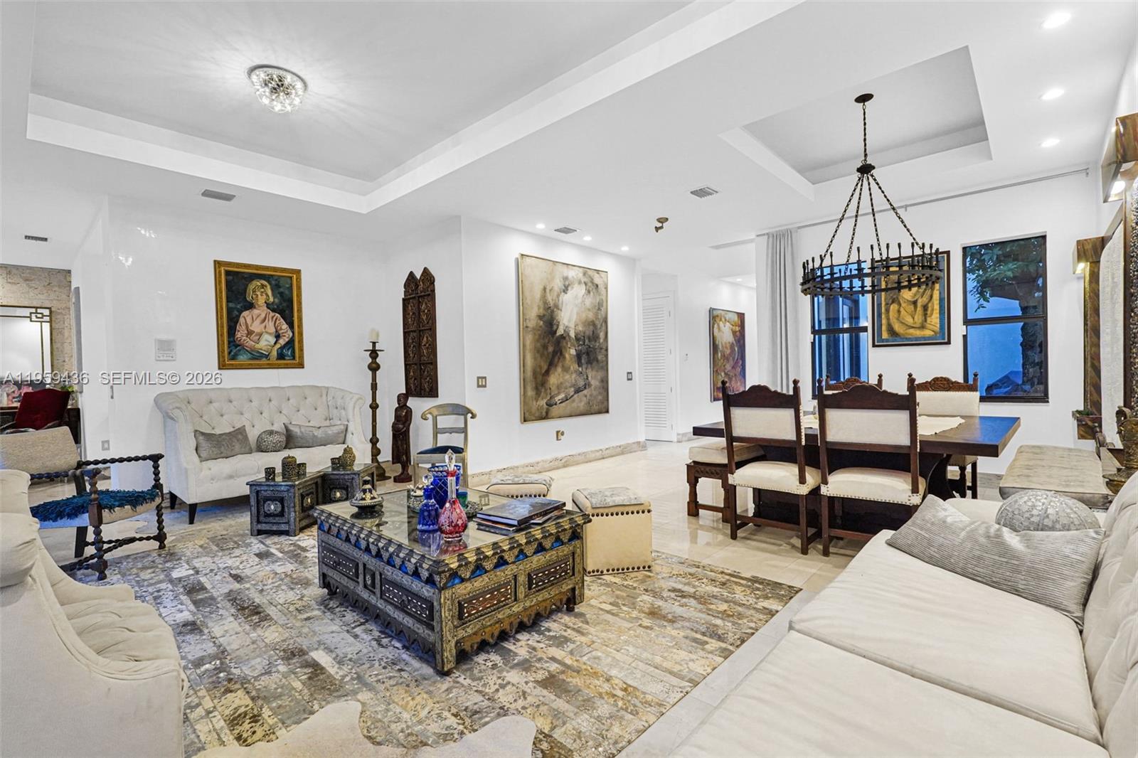 3675 Loquat Avenue Miami, FL 33133 - Photo 34 of 65 a living room with furniture or couch and a chandelier