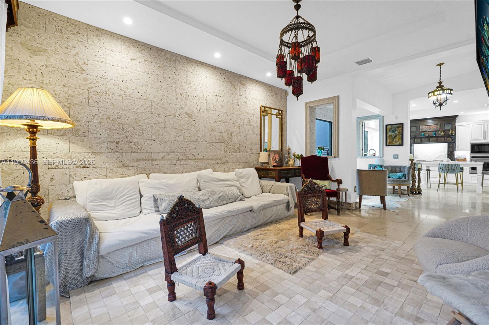 3675 Loquat Avenue Miami, FL 33133 - Photo 39 of 65 a living room with furniture a chandelier and a window