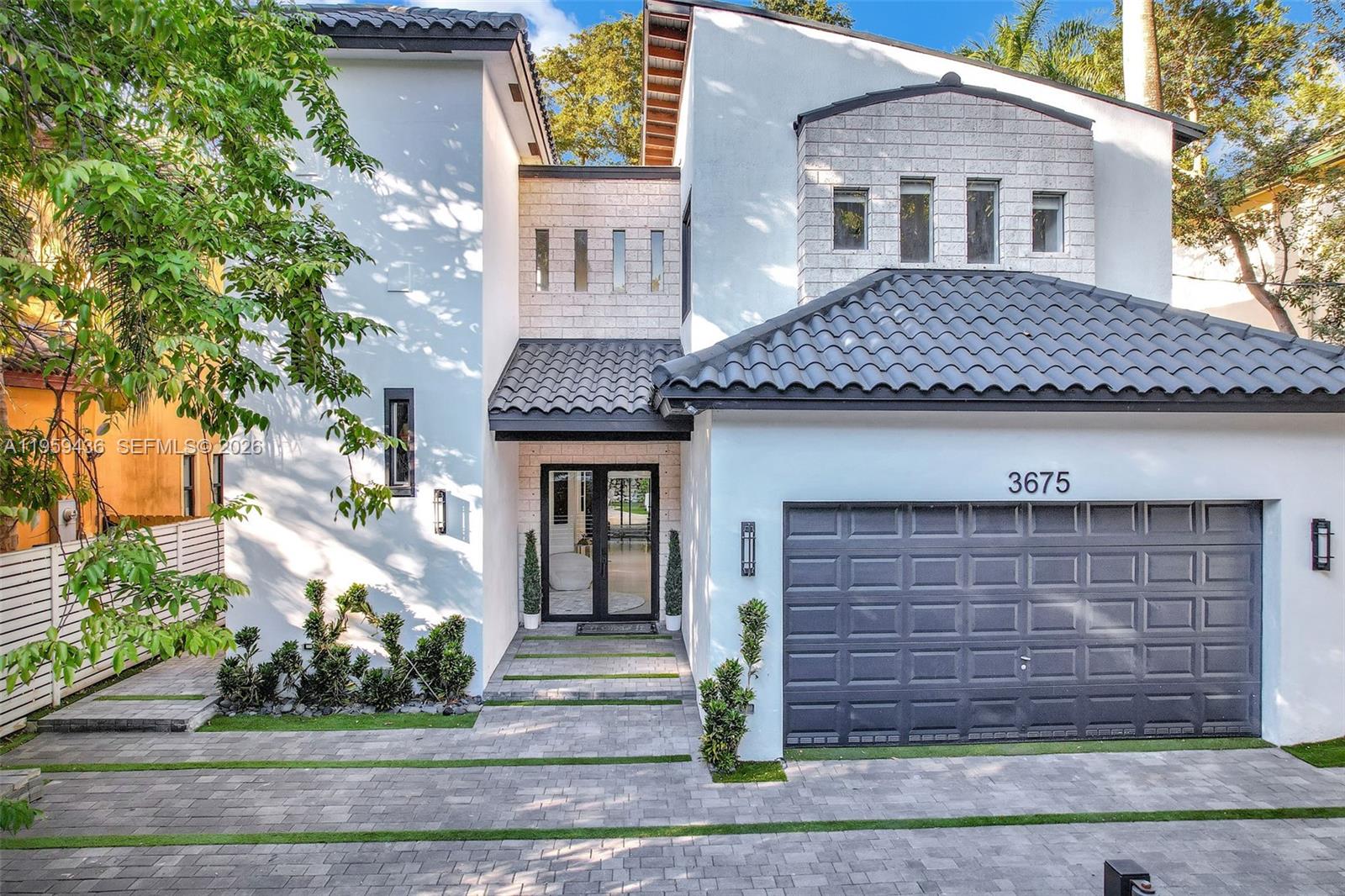 3675 Loquat Avenue Miami, FL 33133 - Photo 4 of 65 a front view of a house with garden