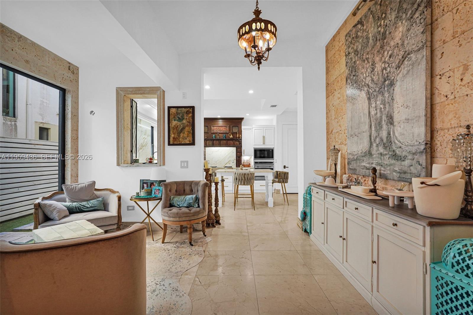3675 Loquat Avenue Miami, FL 33133 - Photo 41 of 65 a view of a kitchen center island and living room