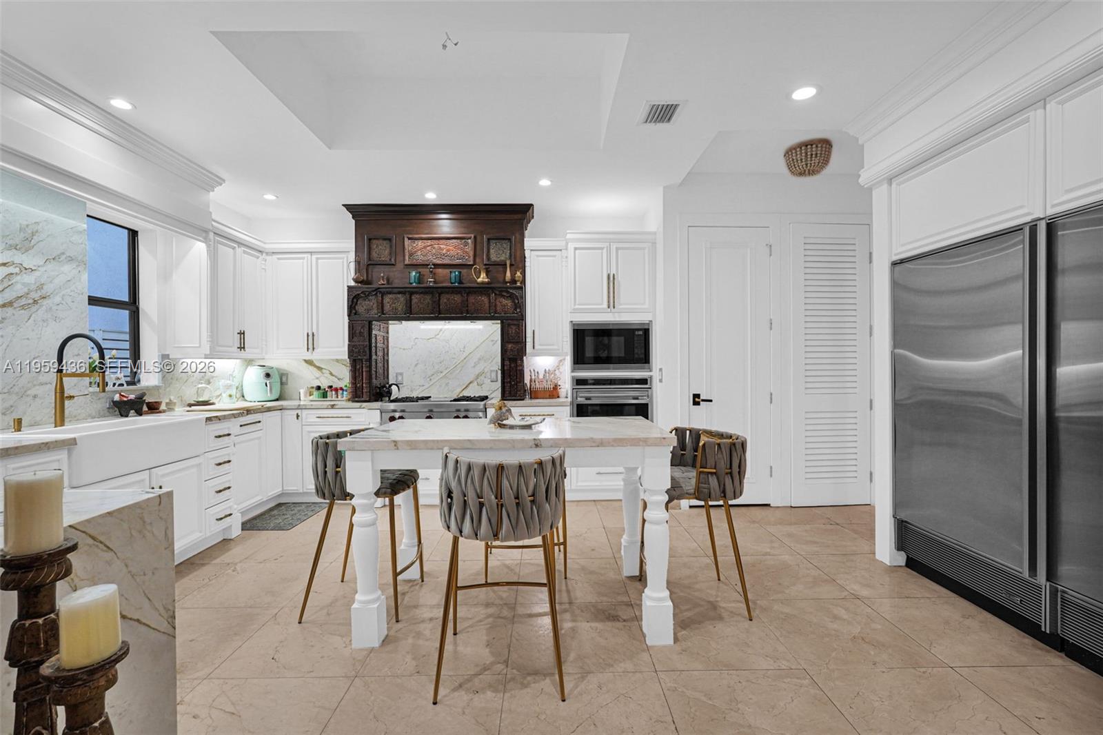 3675 Loquat Avenue Miami, FL 33133 - Photo 42 of 65 a kitchen with a sink chairs and refrigerator