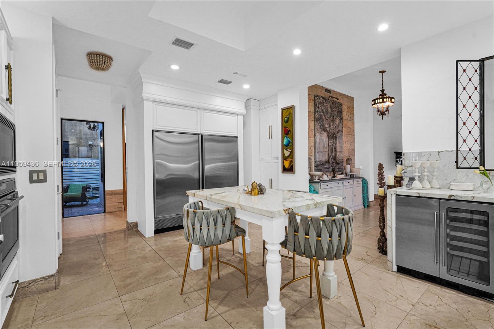 3675 Loquat Avenue Miami, FL 33133 - Photo 48 of 65 a view of a kitchen with kitchen island granite countertop lots of counter top space and stainless steel appliances