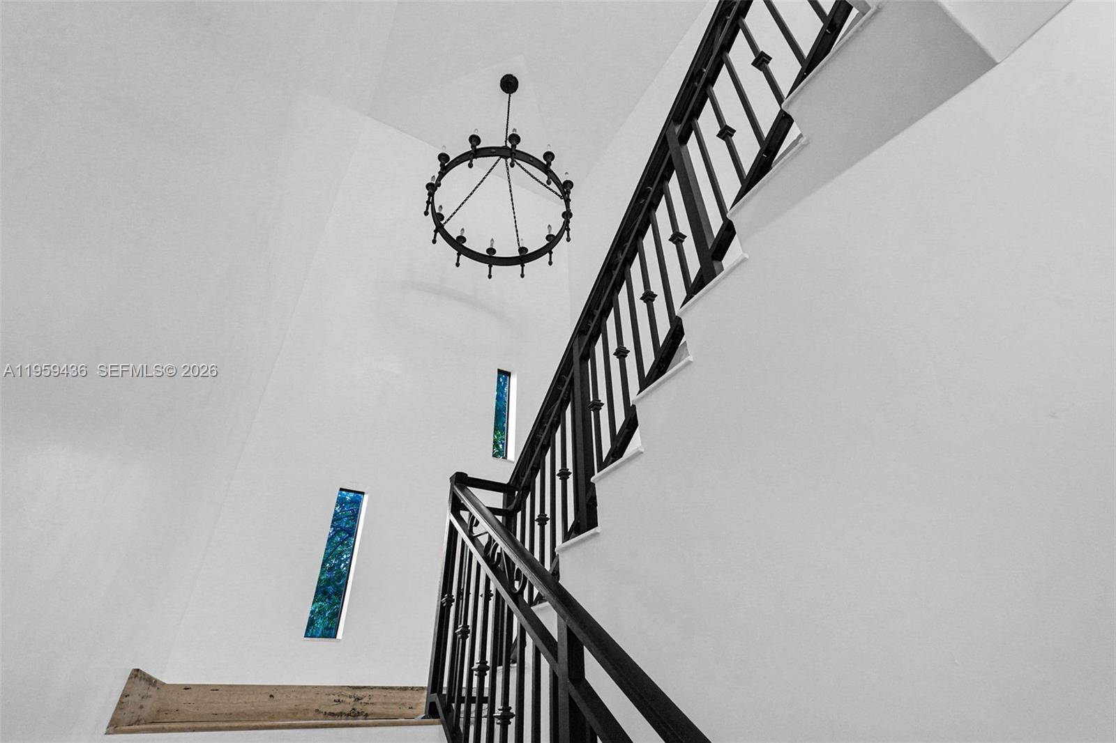 3675 Loquat Avenue Miami, FL 33133 - Photo 49 of 65 a view of entryway with wooden floor and stairs