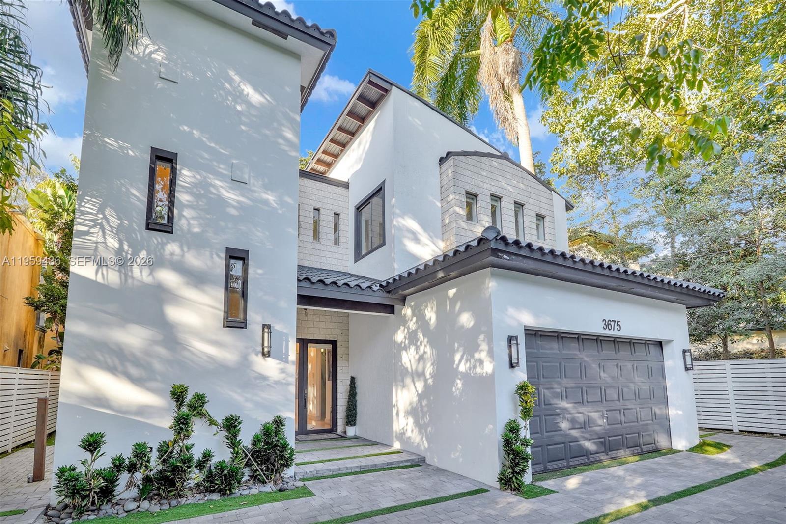 3675 Loquat Avenue Miami, FL 33133 - Photo 5 of 65 a front view of a house with garden