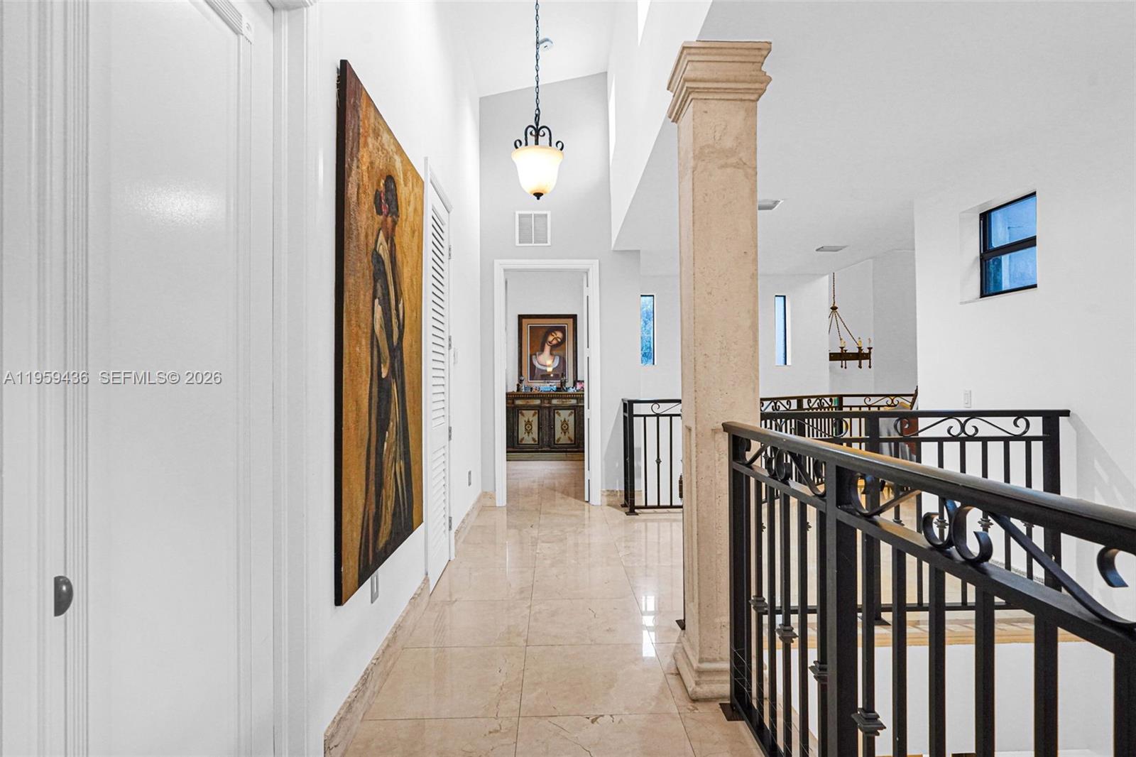 3675 Loquat Avenue Miami, FL 33133 - Photo 51 of 65 a view of a hallway with windows and stairs