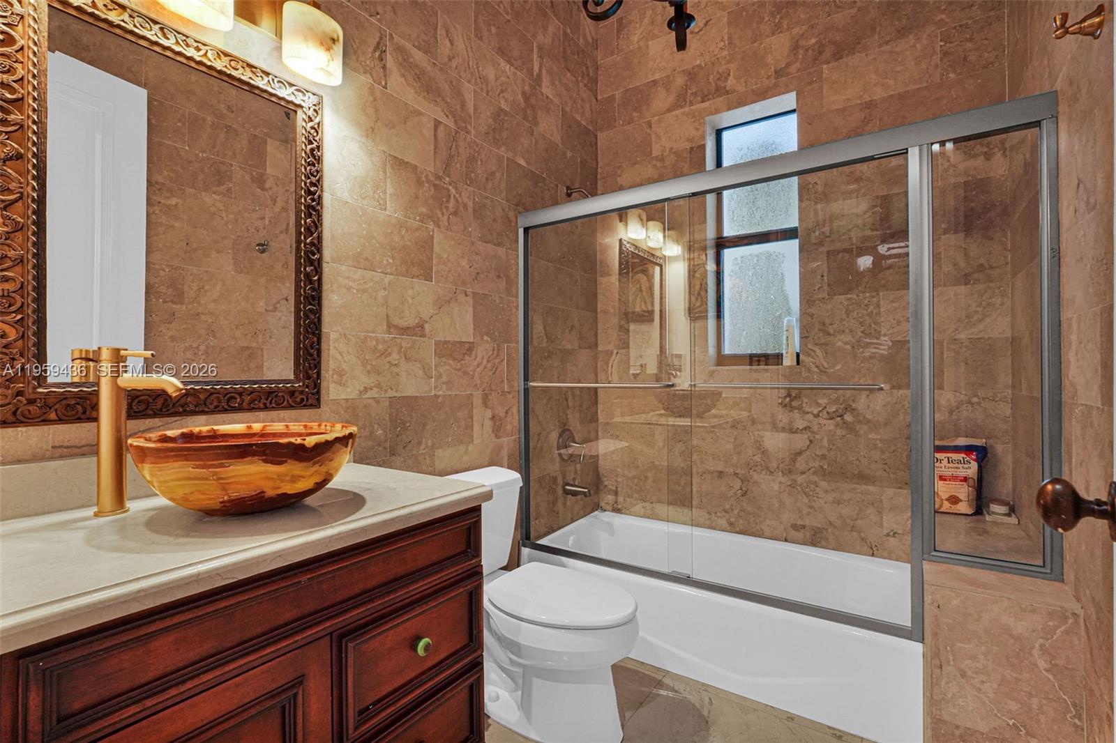 3675 Loquat Avenue Miami, FL 33133 - Photo 55 of 65 a bathroom with a sink a toilet and shower