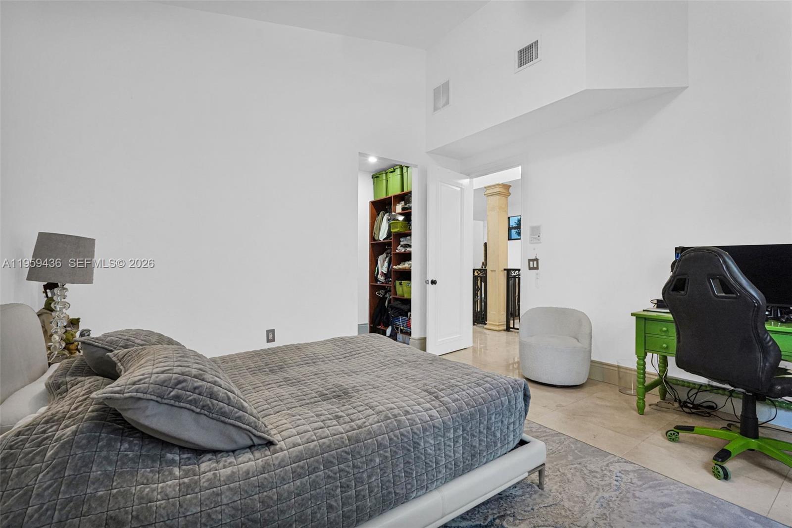 3675 Loquat Avenue Miami, FL 33133 - Photo 57 of 65 a bedroom with a bed and a desk