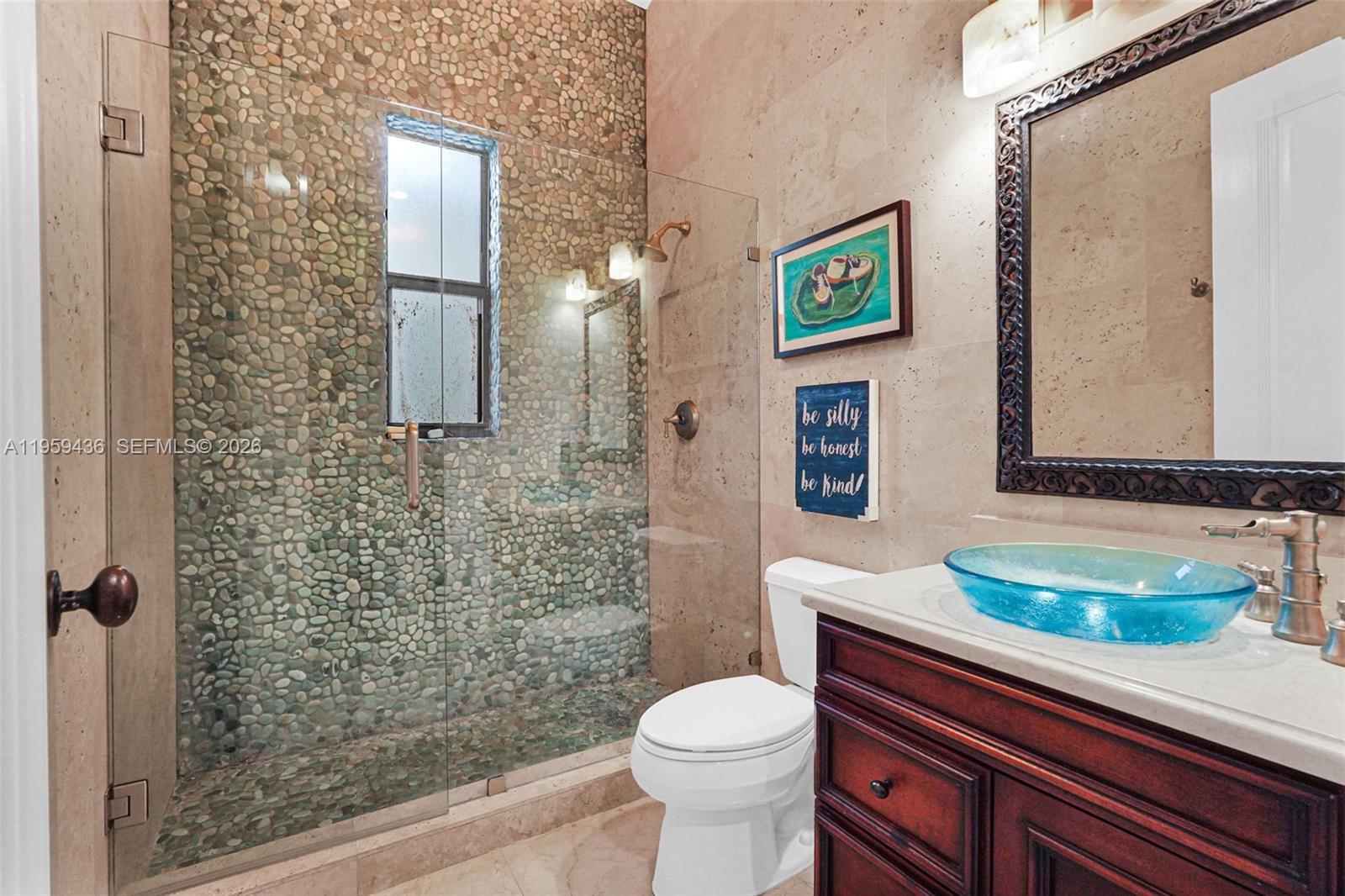 3675 Loquat Avenue Miami, FL 33133 - Photo 58 of 65 a bathroom with a sink a toilet and shower