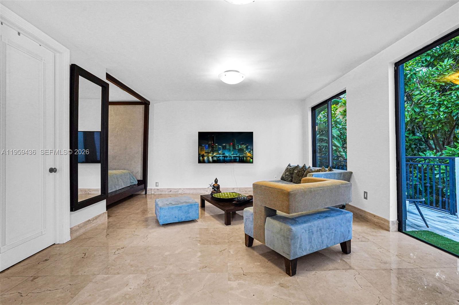 3675 Loquat Avenue Miami, FL 33133 - Photo 60 of 65 a living room with furniture and a flat screen tv
